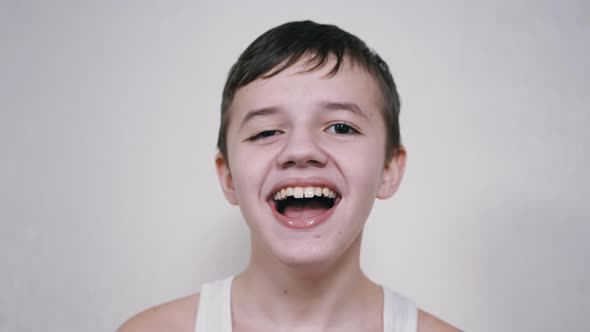 Boy Laughs While Looking at the Camera His Mouth Wide Open Showing His Teeth