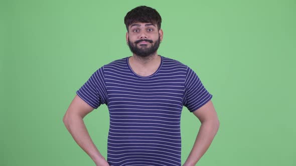 Stressed Young Overweight Bearded Indian Man Looking Bored and Tired