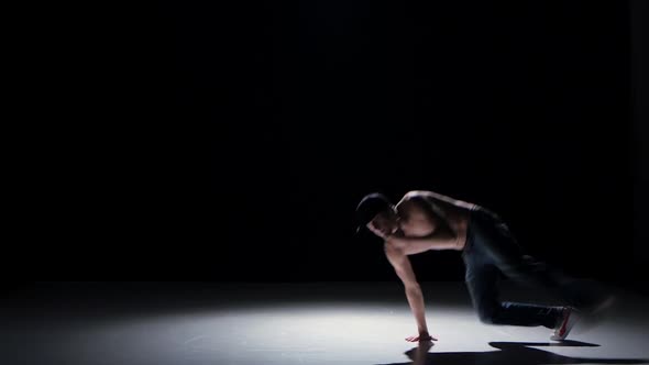 Breakdance Dancer Man with Naked Torso Starts Dance, on Black, Shadow