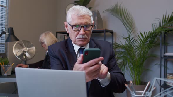 Senior Businessman Grandfather with Smartphone Texting Checking Email Messages Online at Work