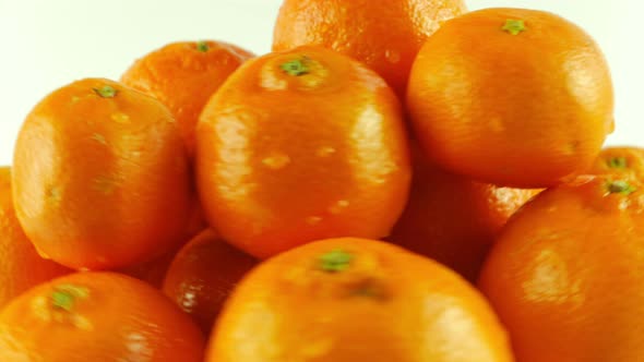 Macro Shot of Rotating Tangerines - White Background