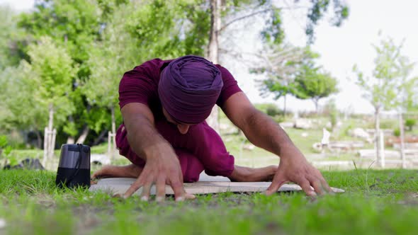 An Arabian Man Does Yoga in the Forest with Music