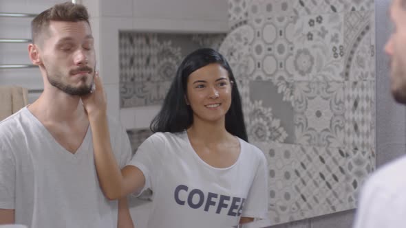 Joyous Woman Applying Shaving Foam to Face of Husband