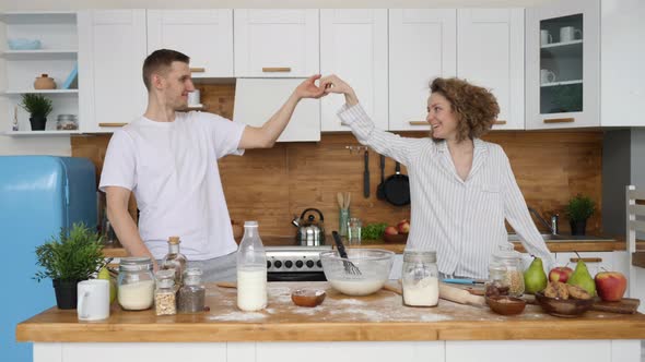 Happy Family Couple Dancing In Kitchen Celebrating Good Morning Full Of Positive Emotions