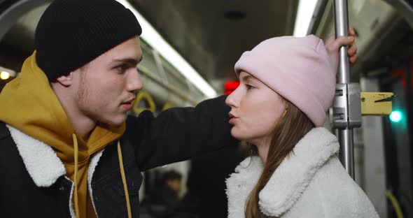 Young Couple Chatting and Looking at Each Other. Millennial Guy and Girl Smiling and Talking While