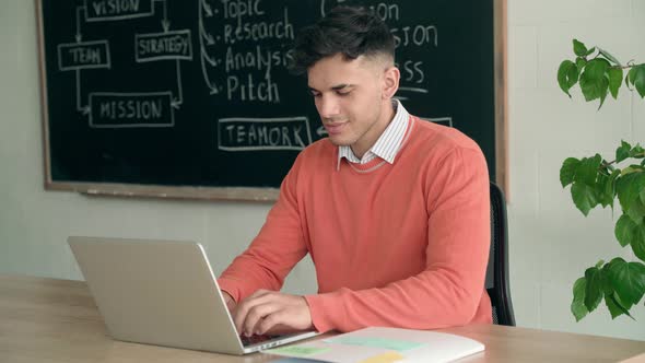 Latin Indian Young Programmer Student Sitting Using Laptop at Modern Office