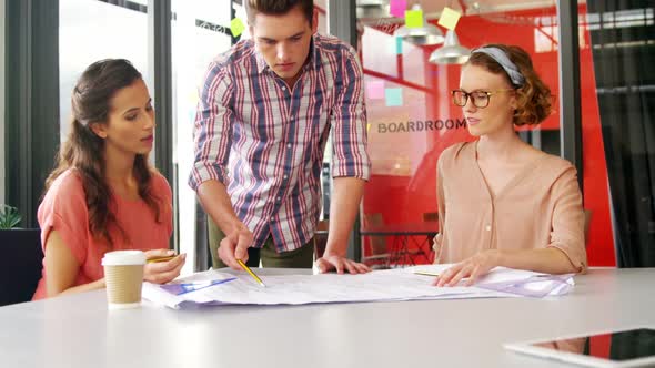 Business executives discussing over project in meeting