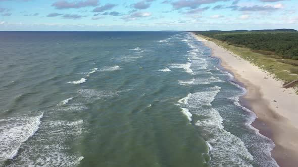 AERIAL: Flying Over Majestic Blue Colour Baltic Sea with Crashing Waves on Windy Day