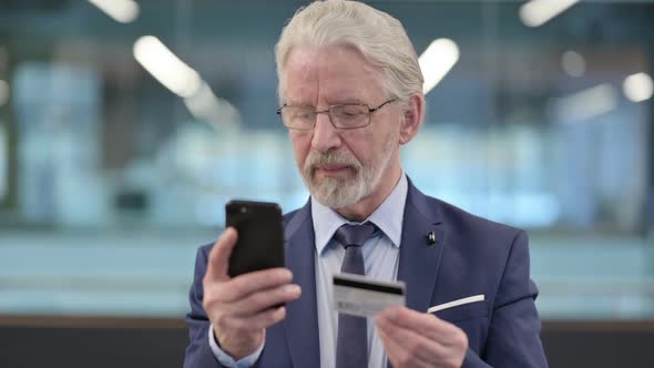 Portrait of Old Businessman Making Successful Online Payment on Smartphone