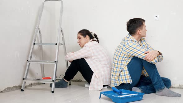 Sad Lady Turns Around with Back to Boyfriend Near White Wall