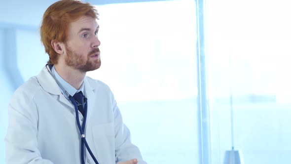 Doctor Sitting in Clinic with Stethoscope in Ears