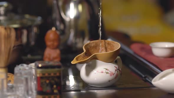 Tea Ceremony. Master Pours the Tea Through a Sieve