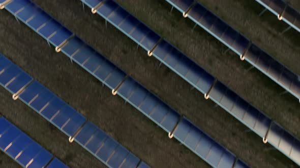 Drone Over Hundreds Of Solar Panels In Rows In Field