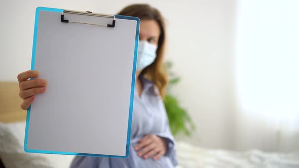 Pregnant Woman Hold White Paper