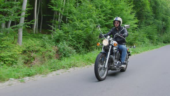 Motorcycle rider on a forest road