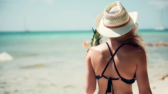 Tanned Girl In Bikini Walking On Sand. Female Tropical Beach. Tanned Woman In Swimsuit.