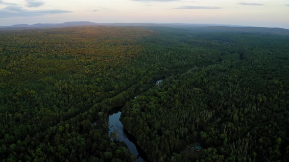 Aerial shot over Piscataquis River at Barrel Falls.