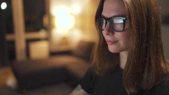 Woman in Glasses Looking on the Monitor and Surfing Internet