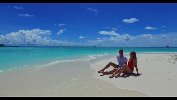 Romantic couple engaged on relaxing coast beach break by blue ocean and white sand background of the