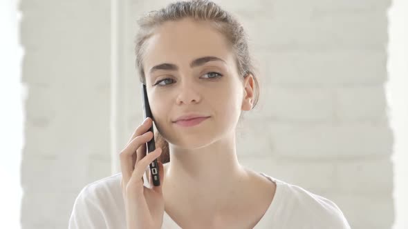 Positive Young Woman Talking on Phone