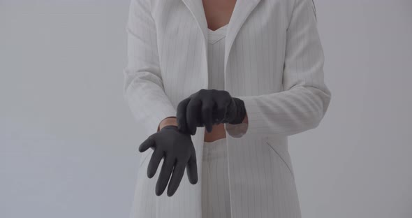 The beautician wears black gloves for examination 