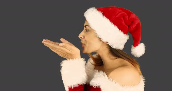 Sexy santa girl blowing over hands 4k
