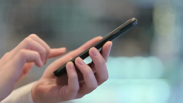 Side View of Female Hands Typing on Smartphone