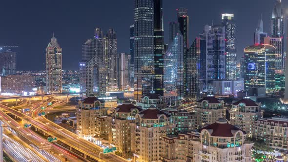 Aerial View of Illuminated Skyscrapers and Road Junction in Dubai Timelapse