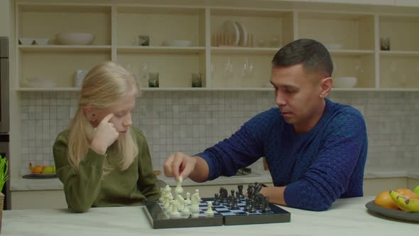 Caring Deaf Father Teaching School Age Daughter with Hearing Loss to Play Chess