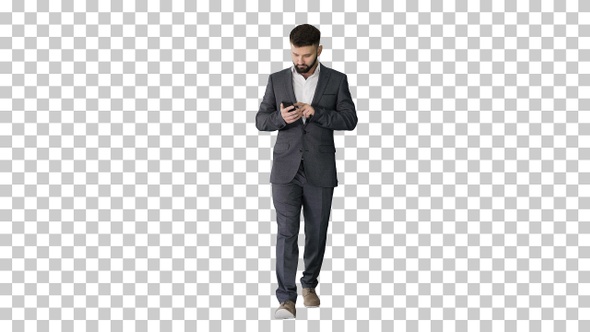 Businessman walking and using the phone, Alpha Channel