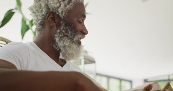 Video of sad african american senior man playing the guitar