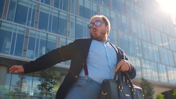 Successful Businessman Dancing and Celebrating Triumph Outdoors