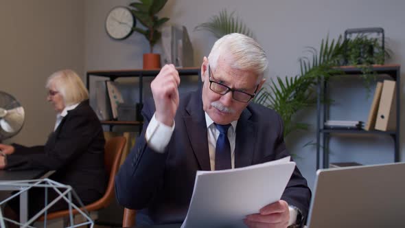 Senior Business Company Manager Sitting at Office Desk Reading Resume Successful Job Interview