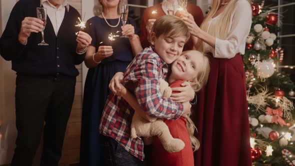 Children Hugging at the Celebration of New Year 2022 Parents Have Bengal Lights