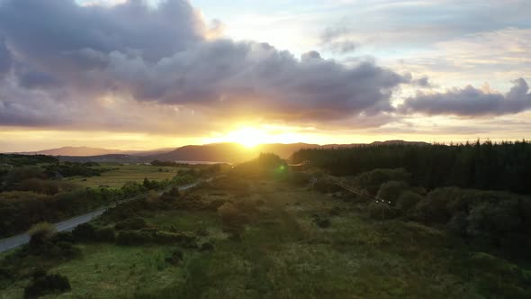 Flying Into the Sunrise Over a Peatbog in County Donegal - Ireland.