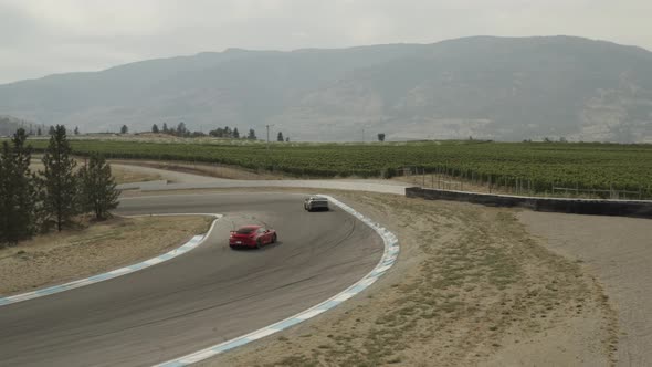 Back view of Exotic cars driving on Osoyoos race track, Area 27 Luxury Motorsports Club, Canada. Aer