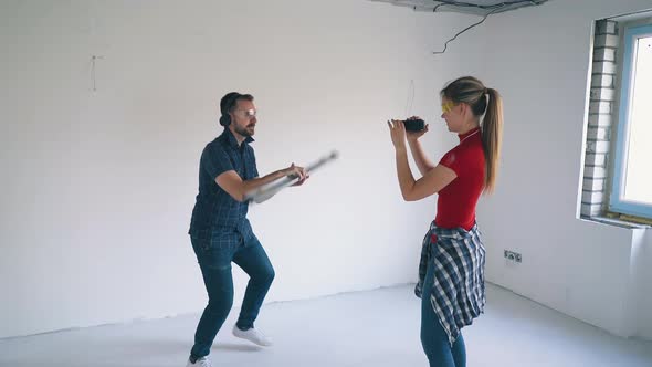 Funny Man Turns Level and Woman Takes Pictures in Room