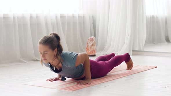 Woman Doing Upward-facing Dog Pose at Yoga Studio 