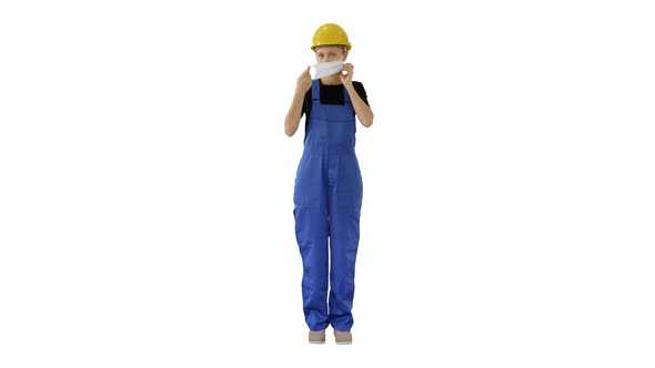 Female Construction Worker Putting on Medical Mask on White Background