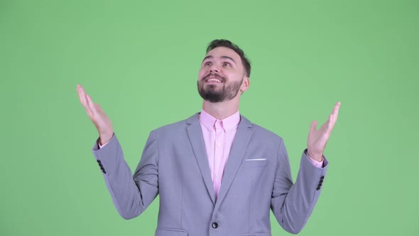 Happy Young Bearded Businessman Catching Something