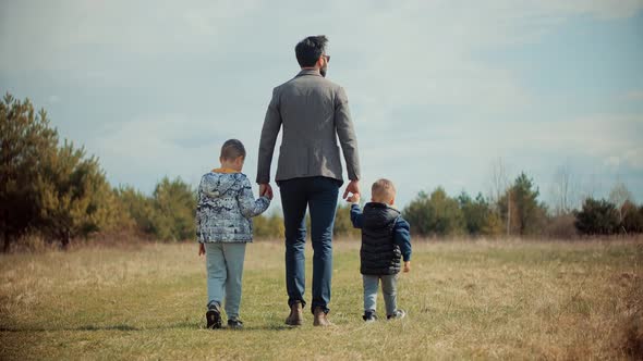 Happy Family Father And Child Boys Leisure. Son Boys Walking Happiness. Cute Little Kid Having Fun.