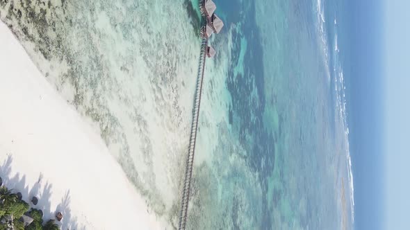 Vertical Video House on Stilts in the Ocean on the Coast of Zanzibar Tanzania Aerial View