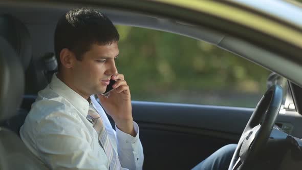 Busy Business Executive Talking on Phone in Car
