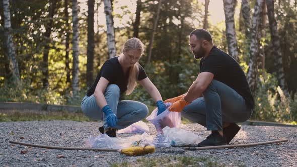 Two Volunteers Picking Up Trash and Rubbish in Their Community Park Not To Far From Their Home