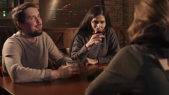 a Group of Young Friends Came To a Cafe To Drink Drinks and Chat