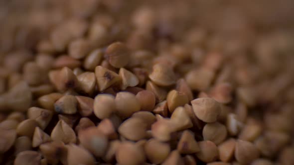 Rotating Raw Buckwheat. Сlose Up Dry Uncooked Seeds. Food Video