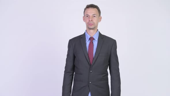 Studio Shot of Happy Businessman Waving Hand