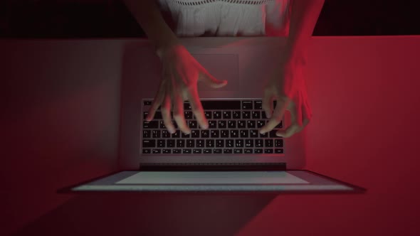 Girl typing message on laptop on white table. Fingers running on keyboard. Freelance online work