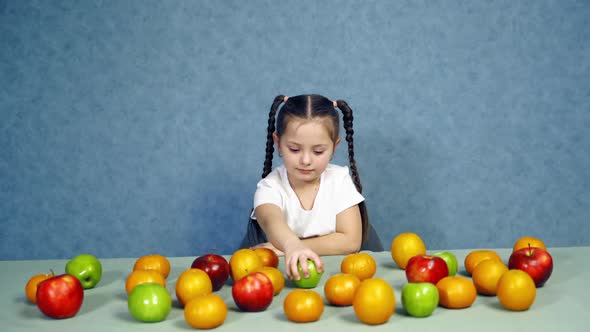 Cheerful kid with fresh fruits. 