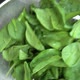 fresh healthy spinach leaves in colander, view from top - VideoHive Item for Sale